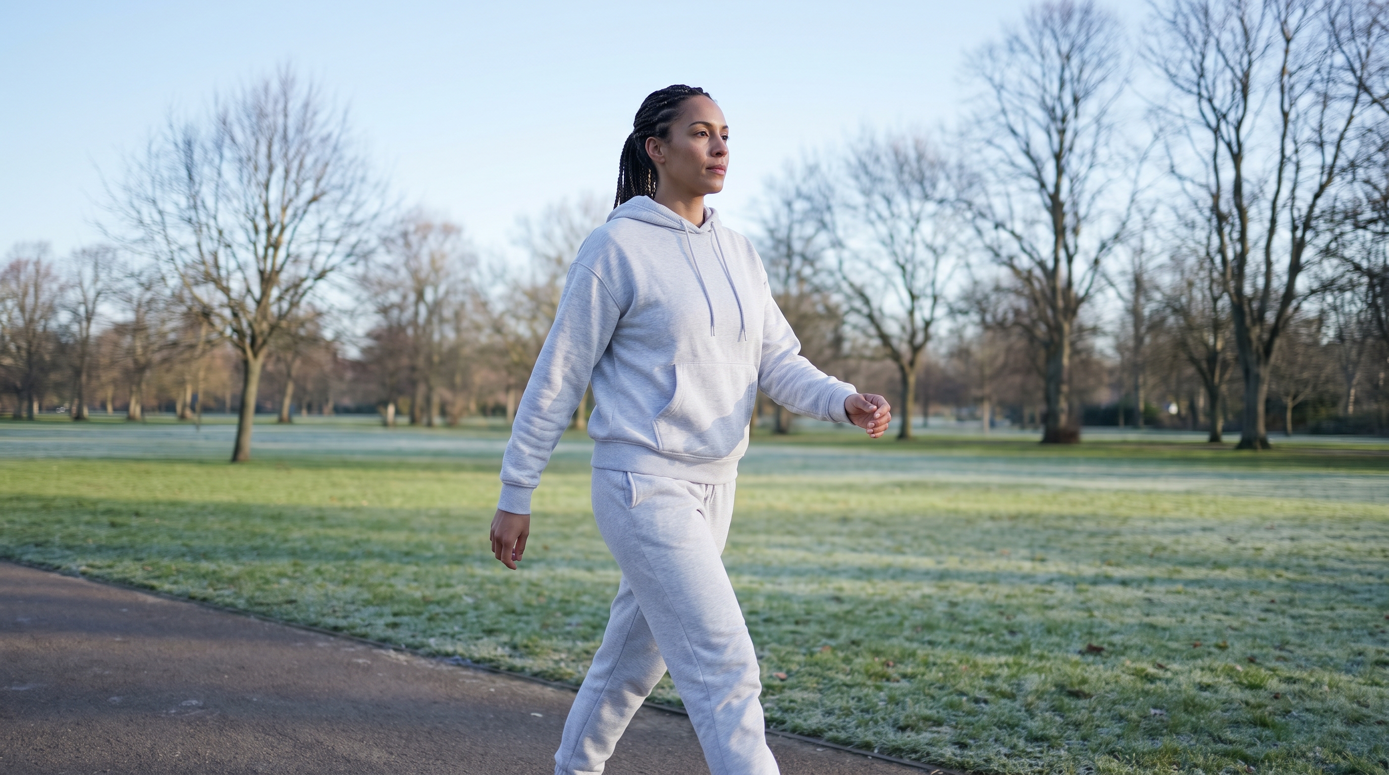 person checking step counter while walking outdoors