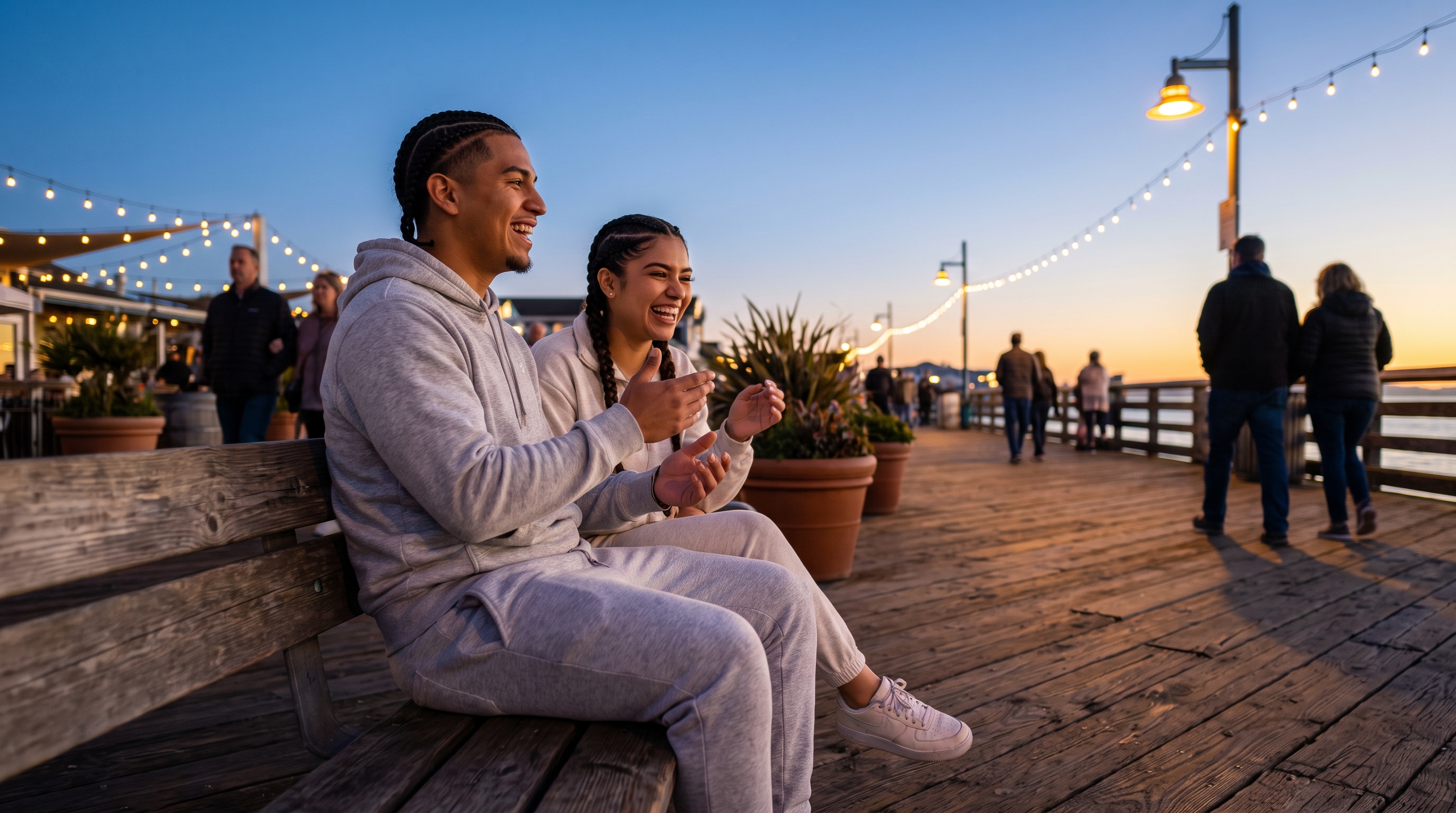 couple sitting close on a park bench at dusk