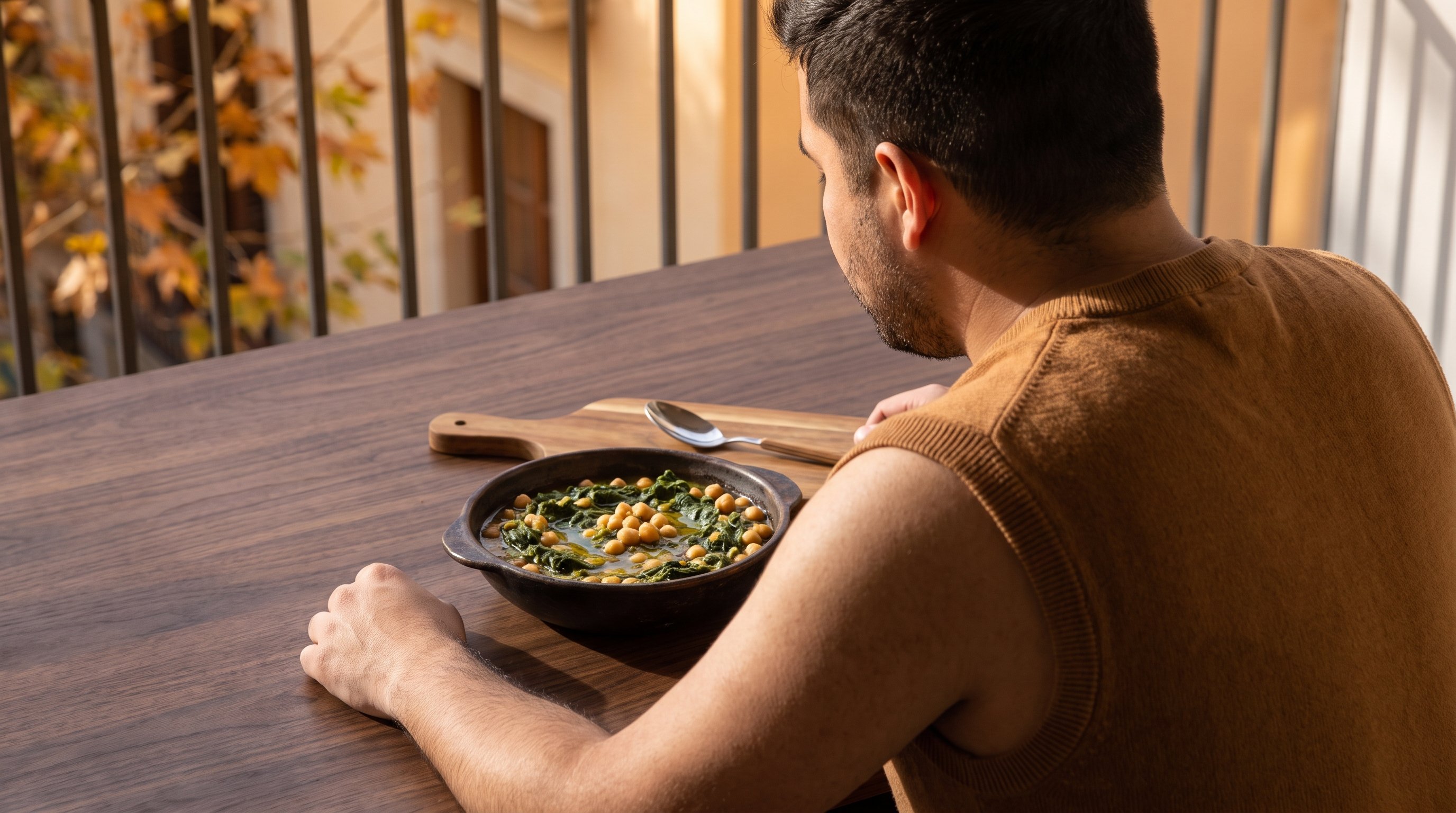 bowl of spinach and chickpeas on a wooden table