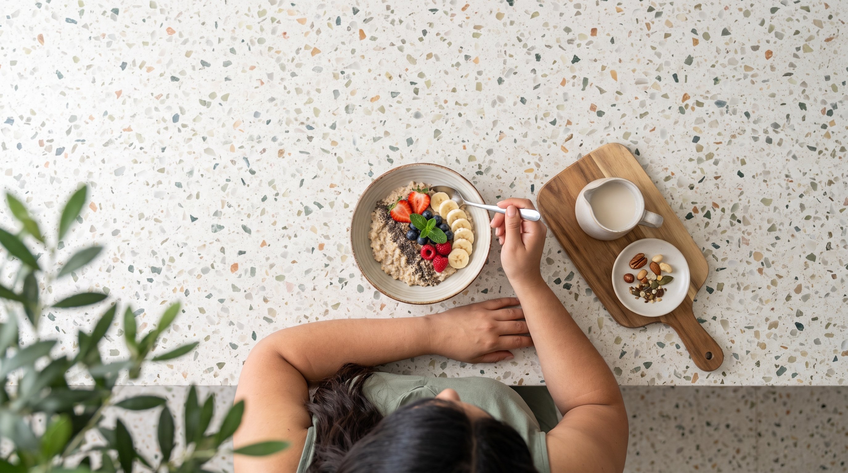 woman writing in a food journal next to a bowl of oats and berries