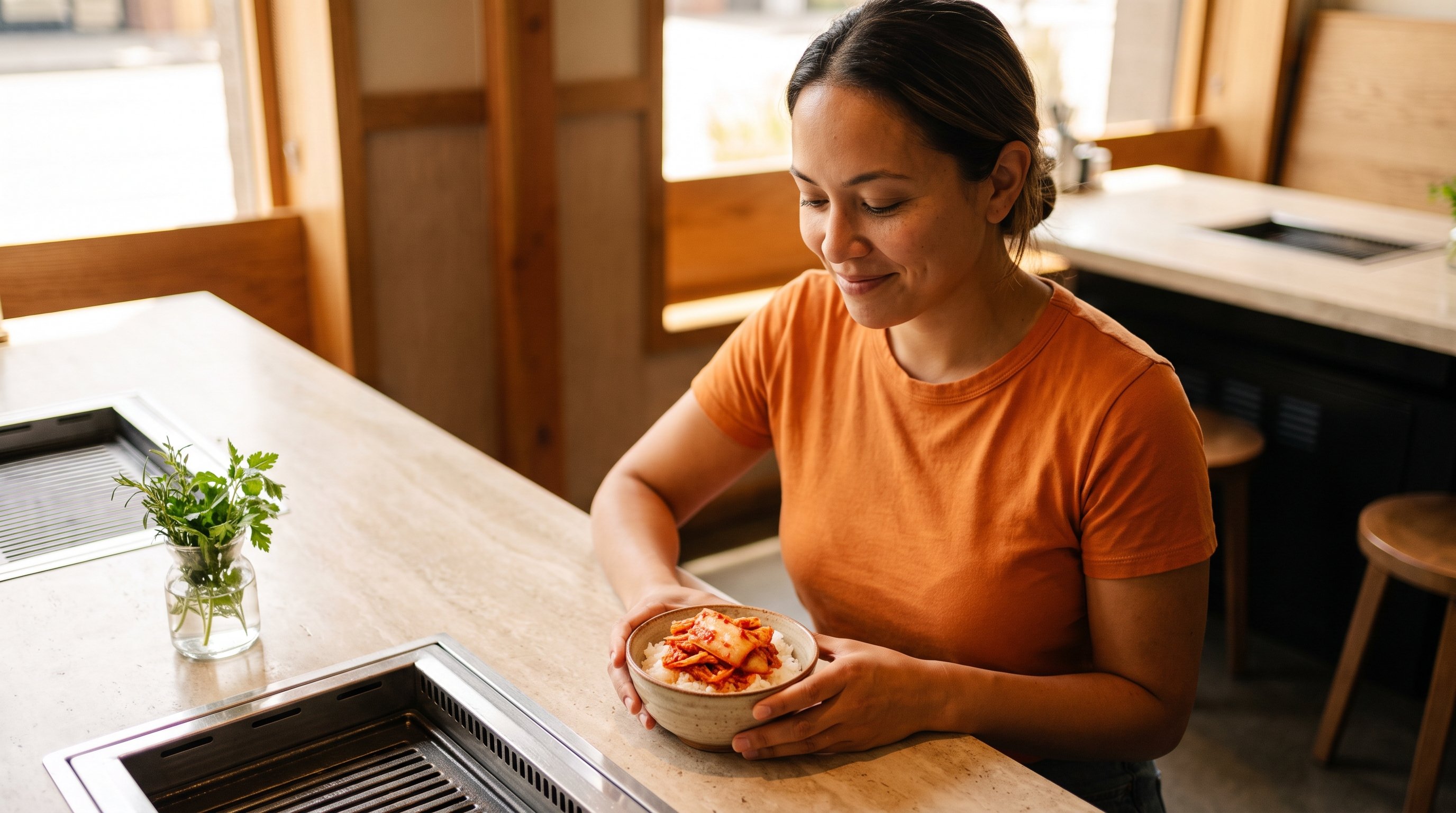 person spooning kimchi onto rice at kitchen counter