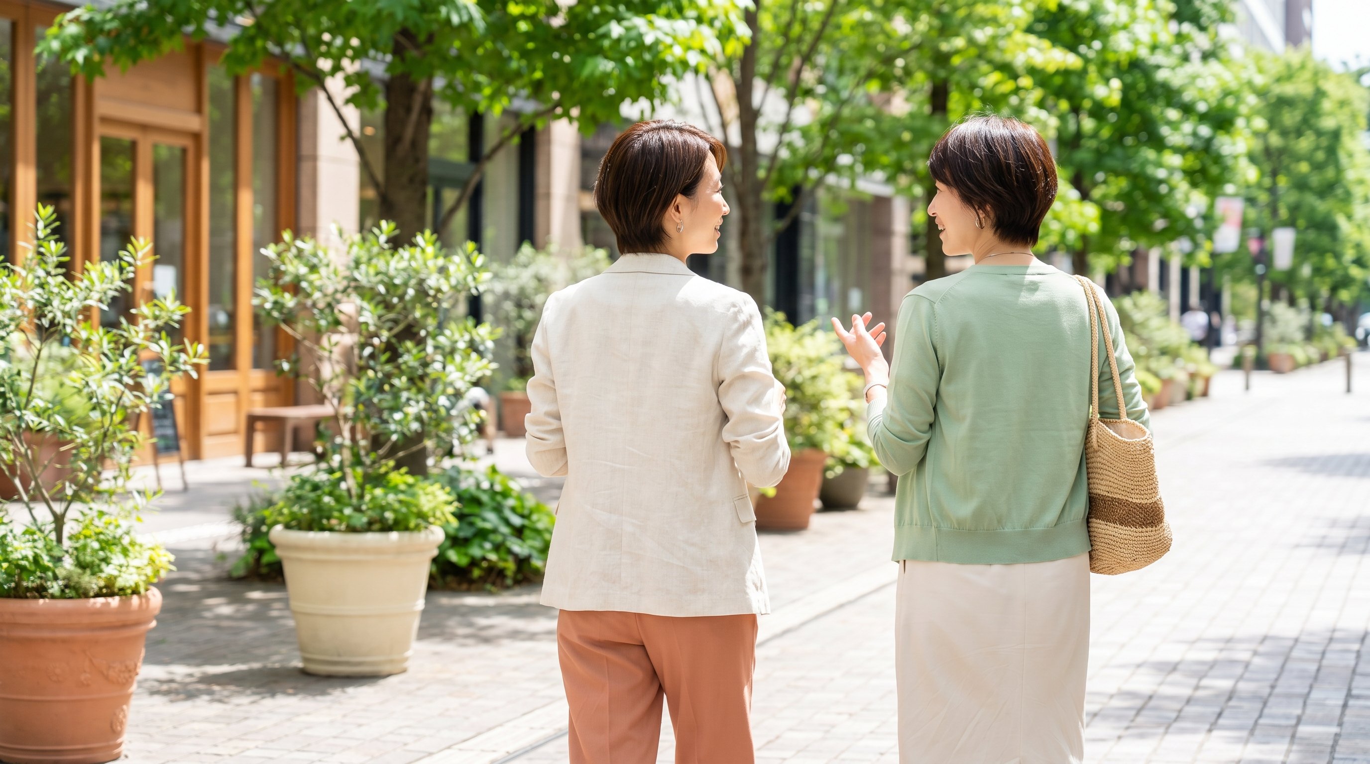 two colleagues walking and talking during a lunch break outdoors
