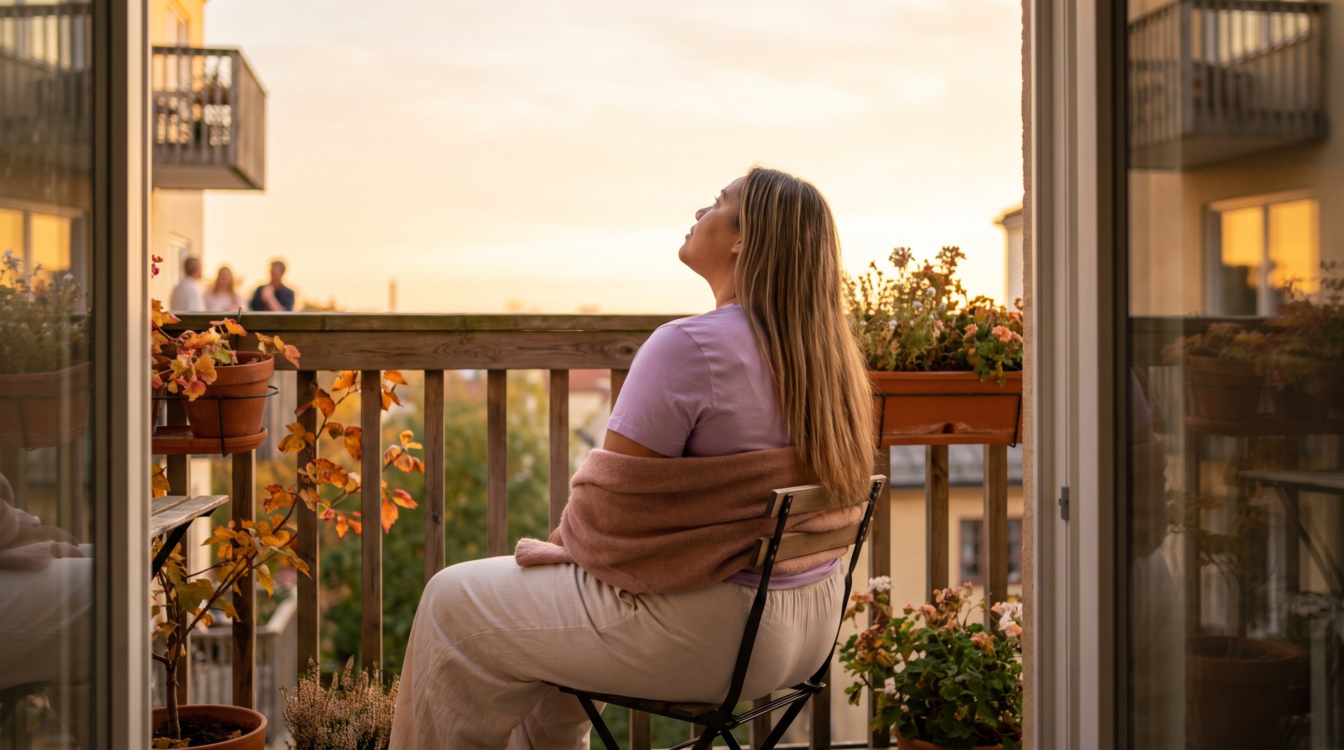person writing in a notebook by a window at dusk