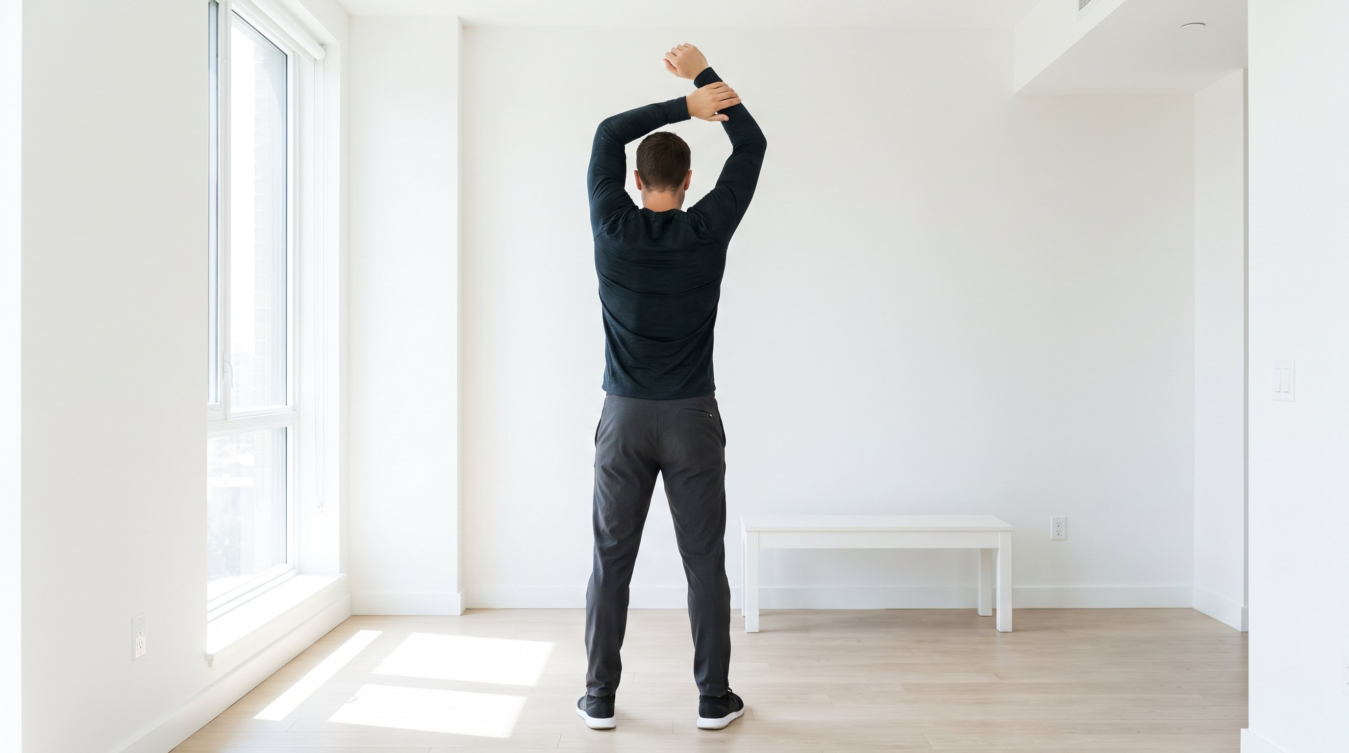 man stretching in living room morning light
