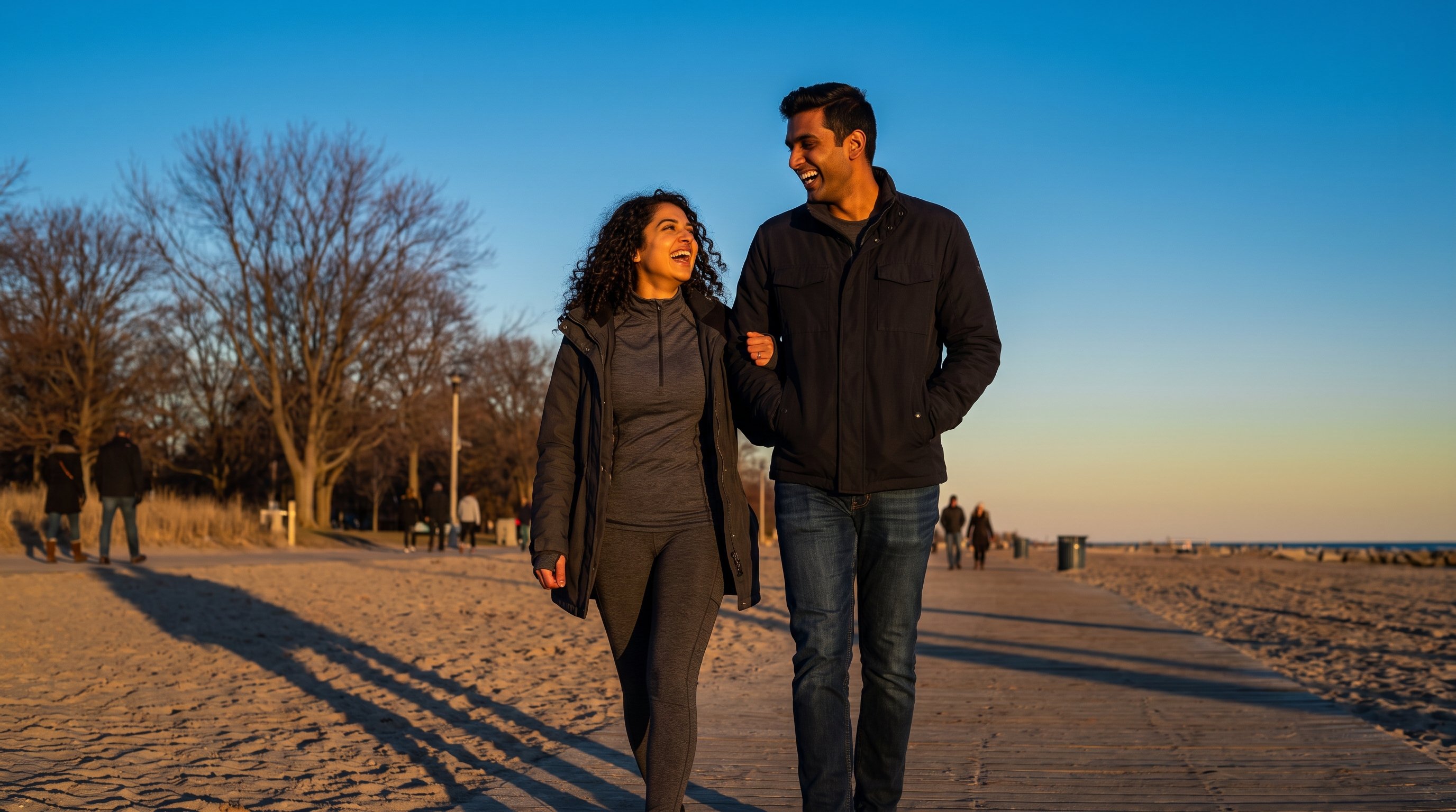 two people laughing together outdoors at sunset