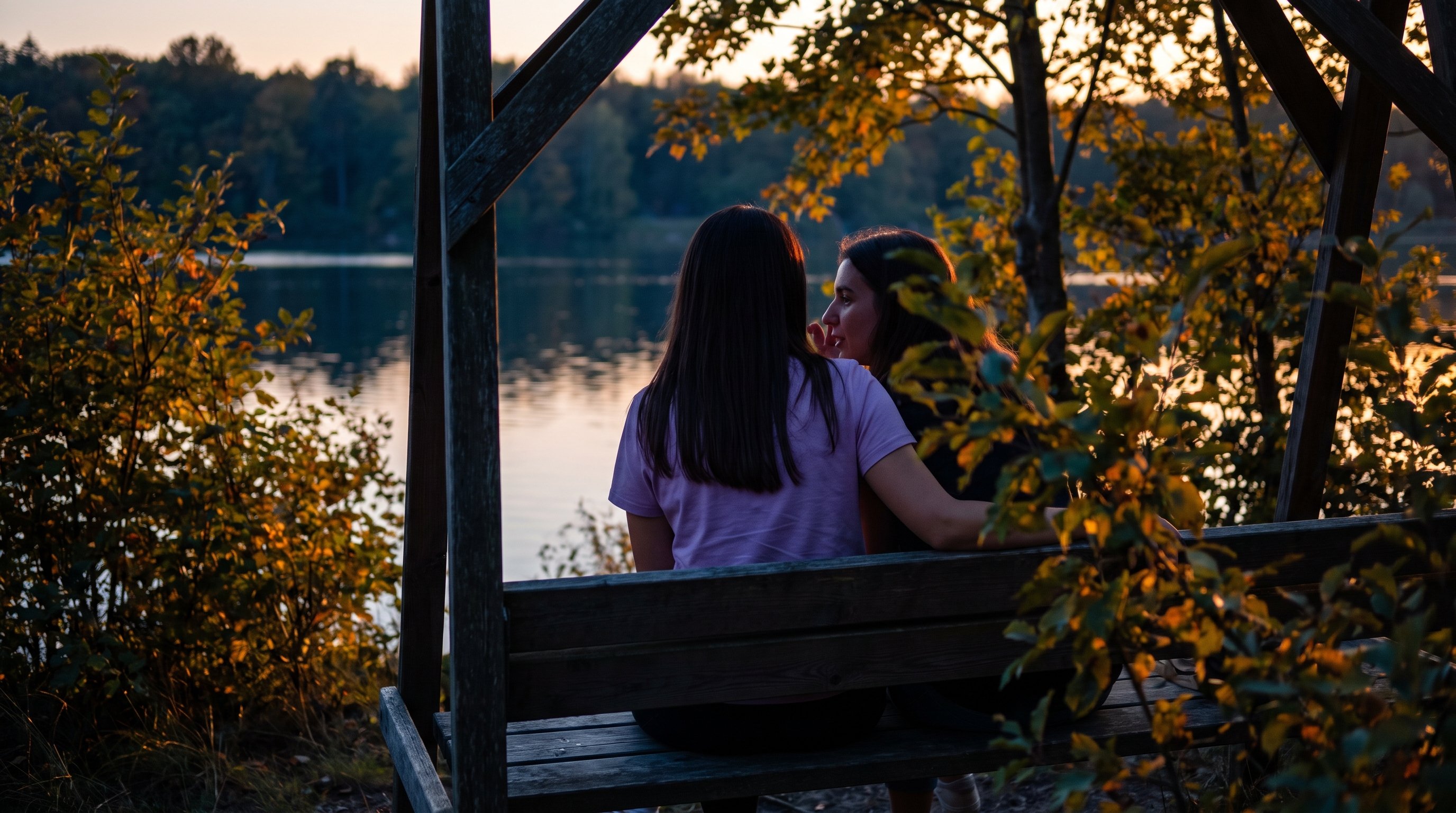 couple sitting close talking on a sofa at home