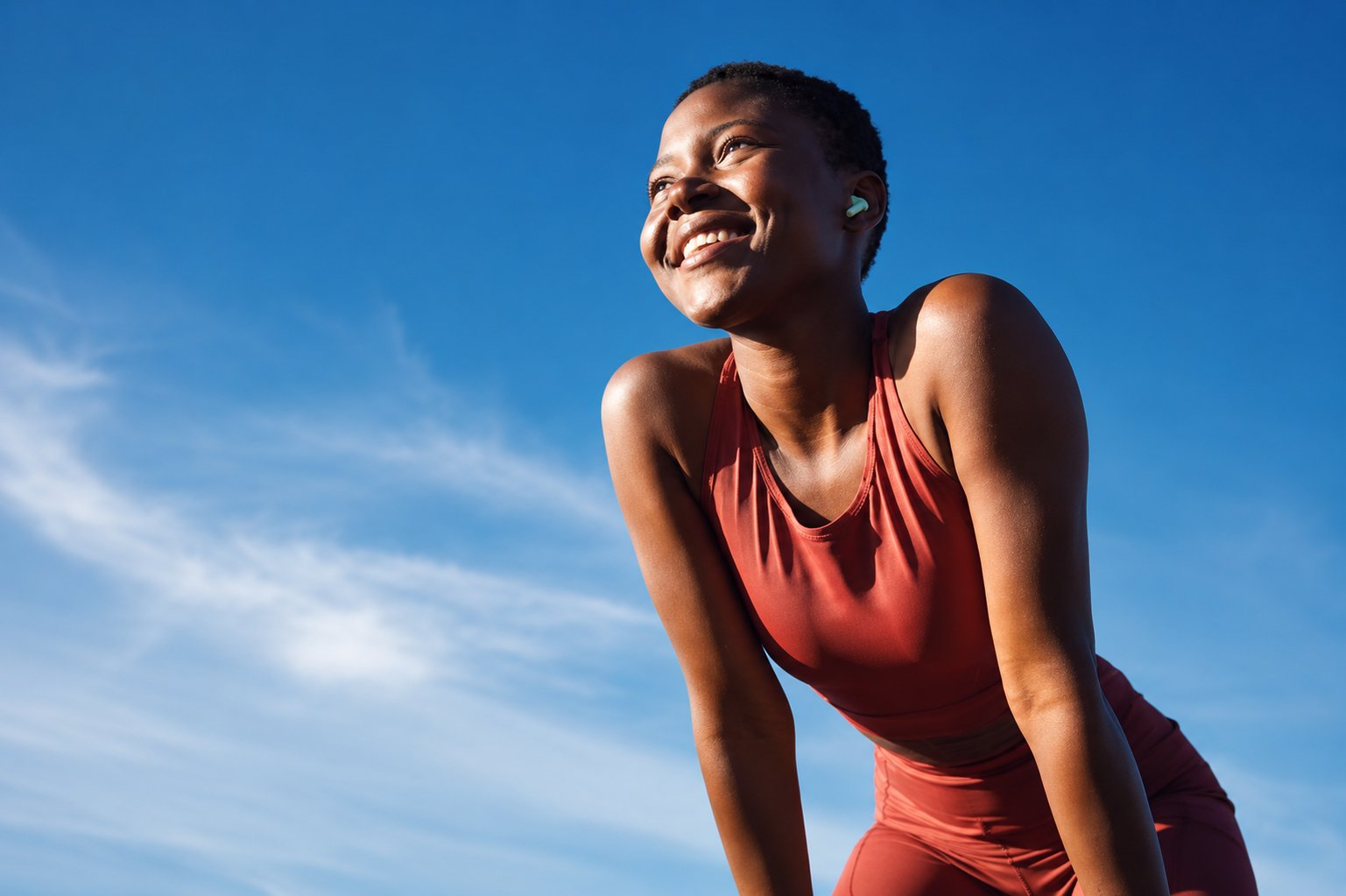 nord-pilates-happy-woman-workout-earbuds-outdoor-fitness-motivation-pilates.png