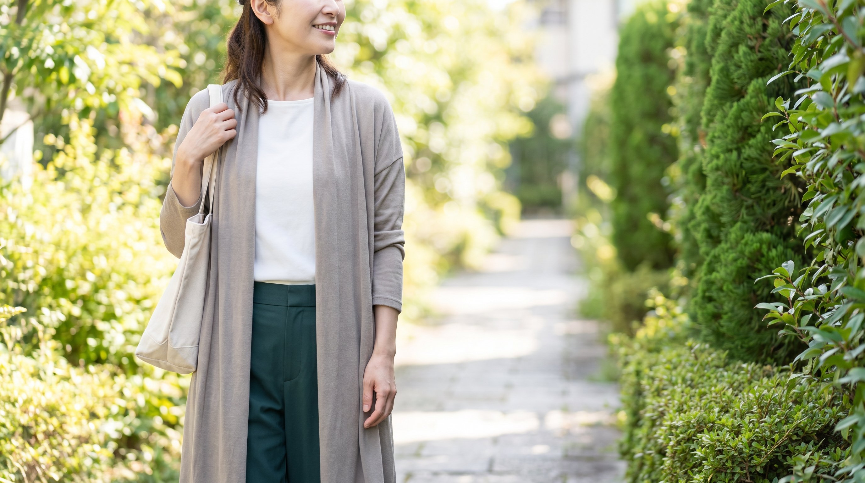 A composed woman in her 40s walking outdoors on a sunny neighbourhood path