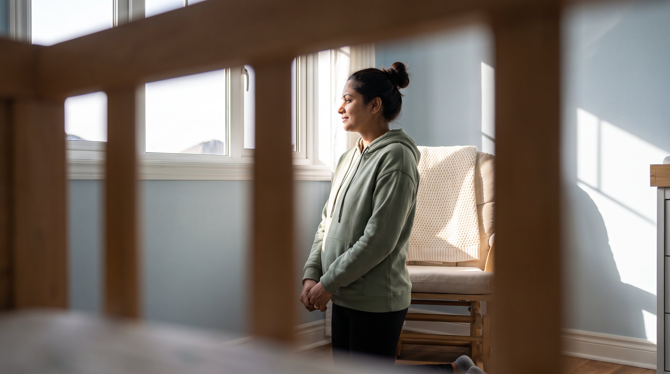 A mother in her early 30s in a cozy nursery in the evening A mother in her early 30s in a cozy nursery in the evening